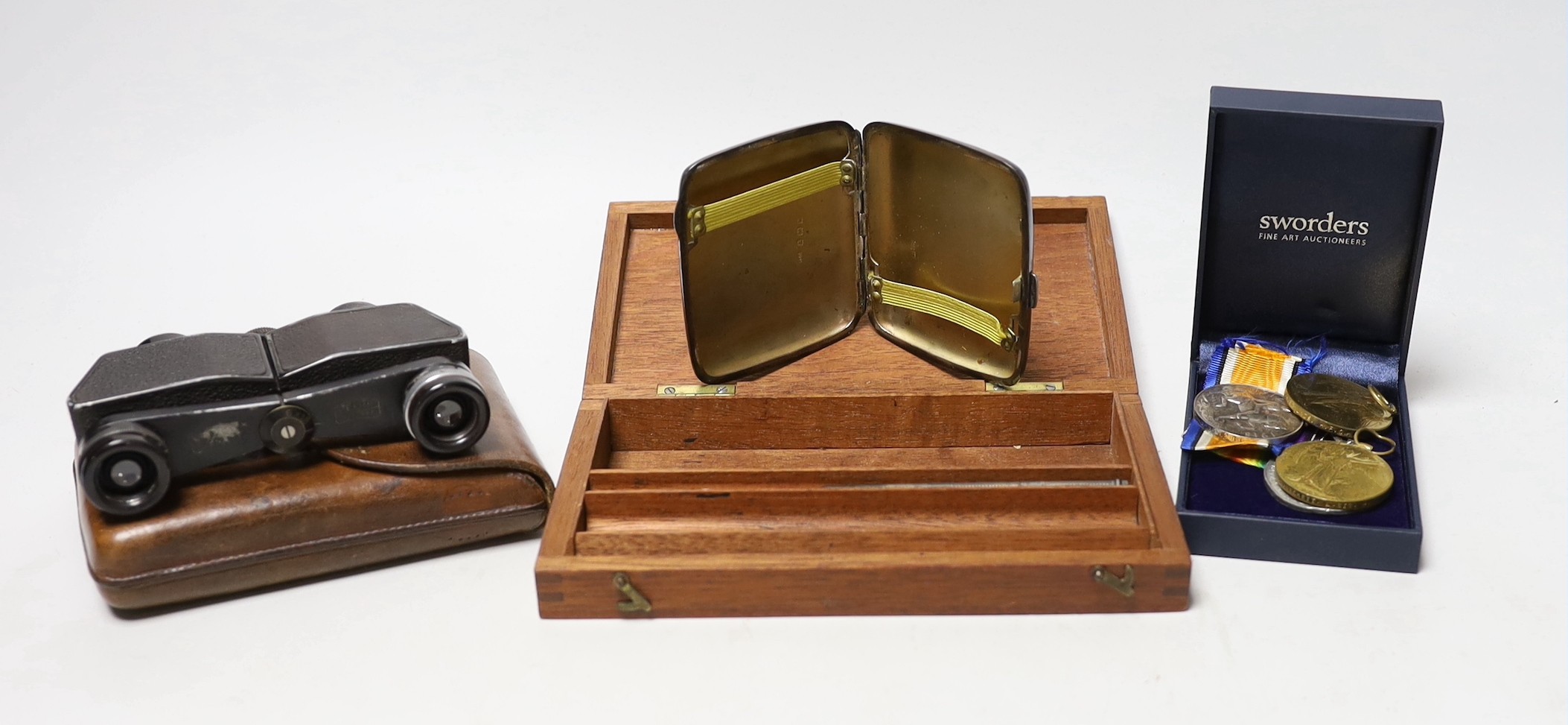 A pair of military binoculars, box of WWI and other medals, a silver card case and artist's box and pencil